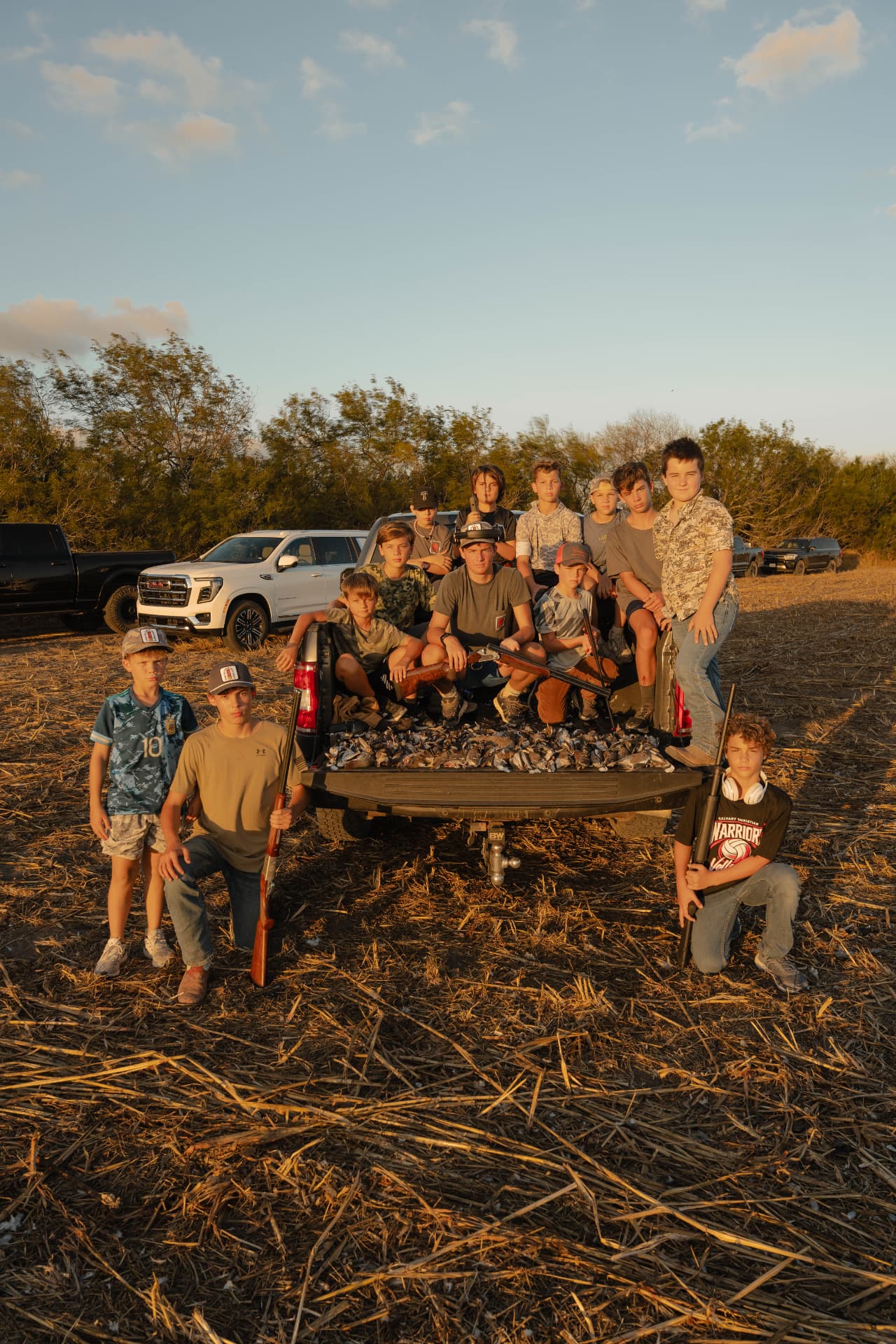 The young shooters posed around a truck loaded with birds