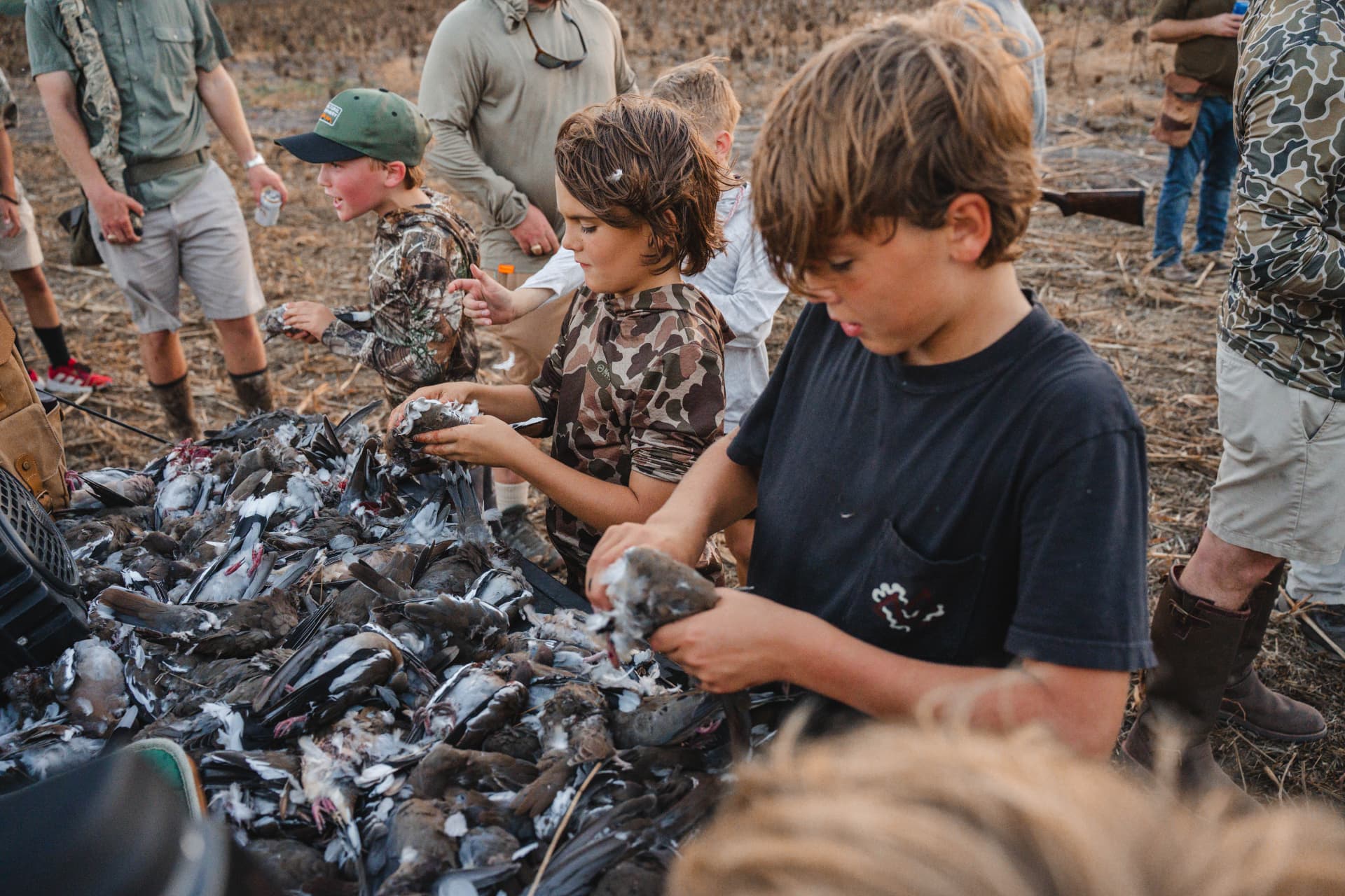 Young hunters cleaning the harvest on the tailgate