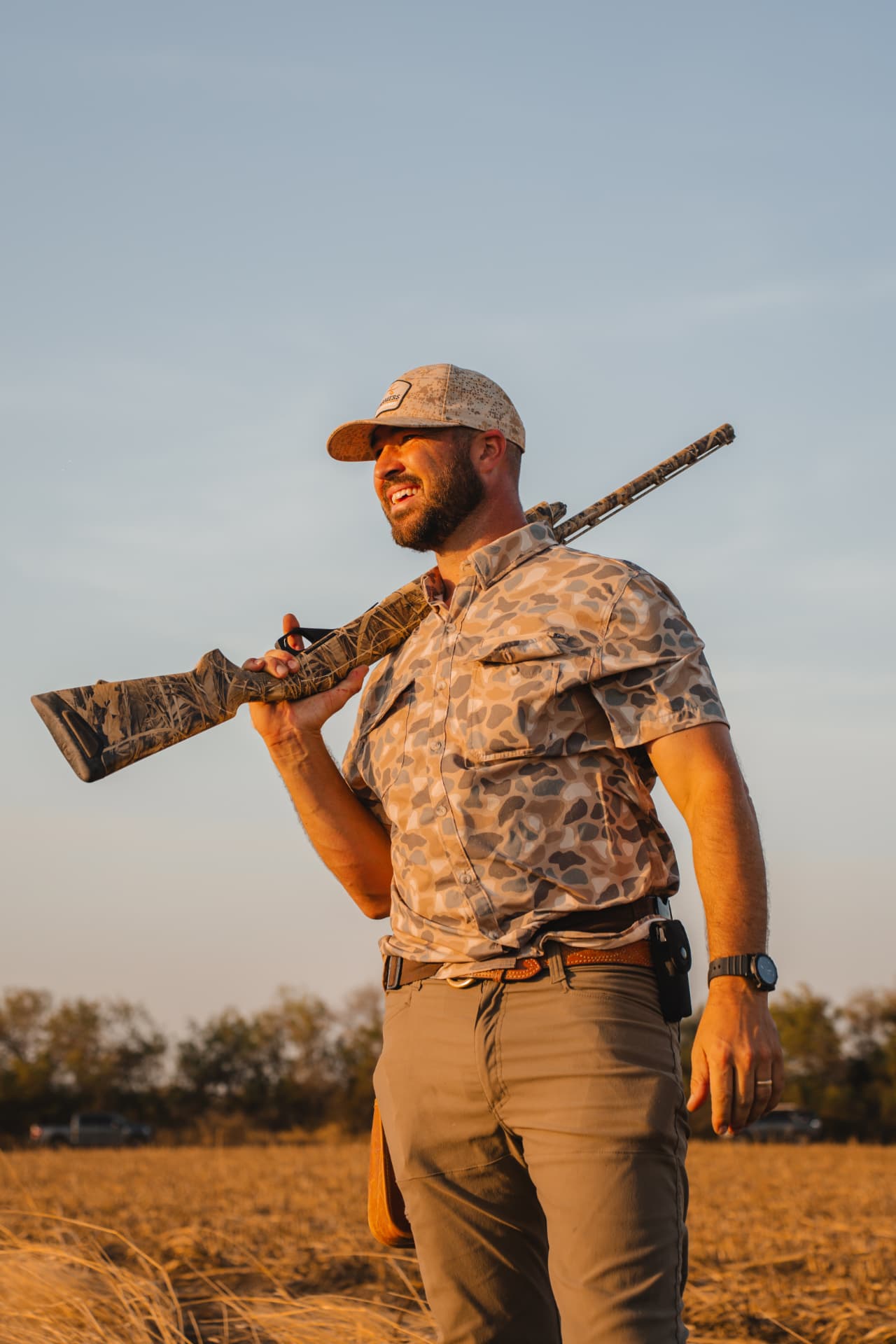 Hunter walking out of the field at golden hour