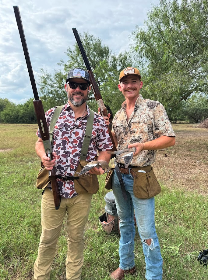 Two hunters posing with doves after a successful round