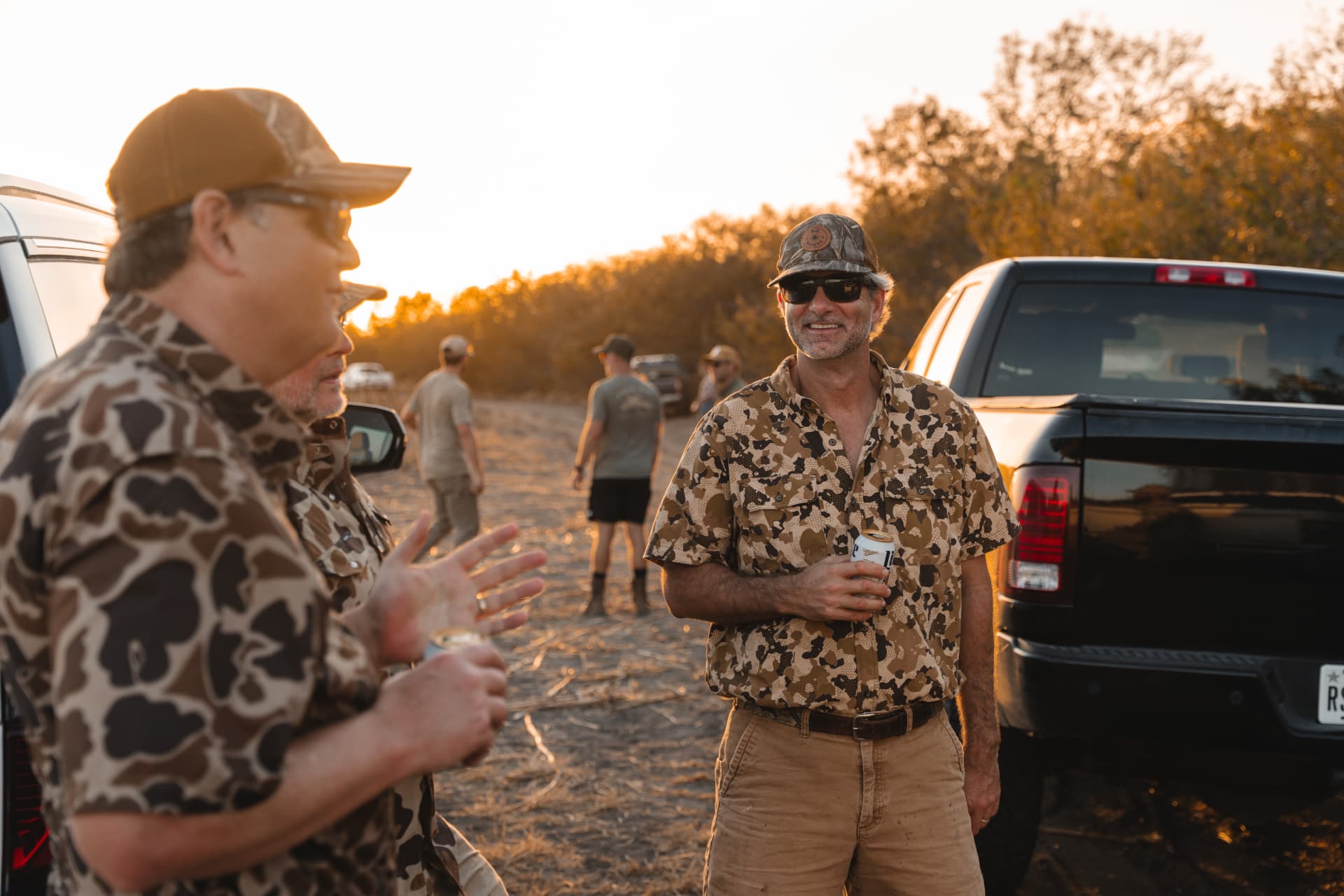 Hunters gathered around the trucks sharing drinks after the shoot