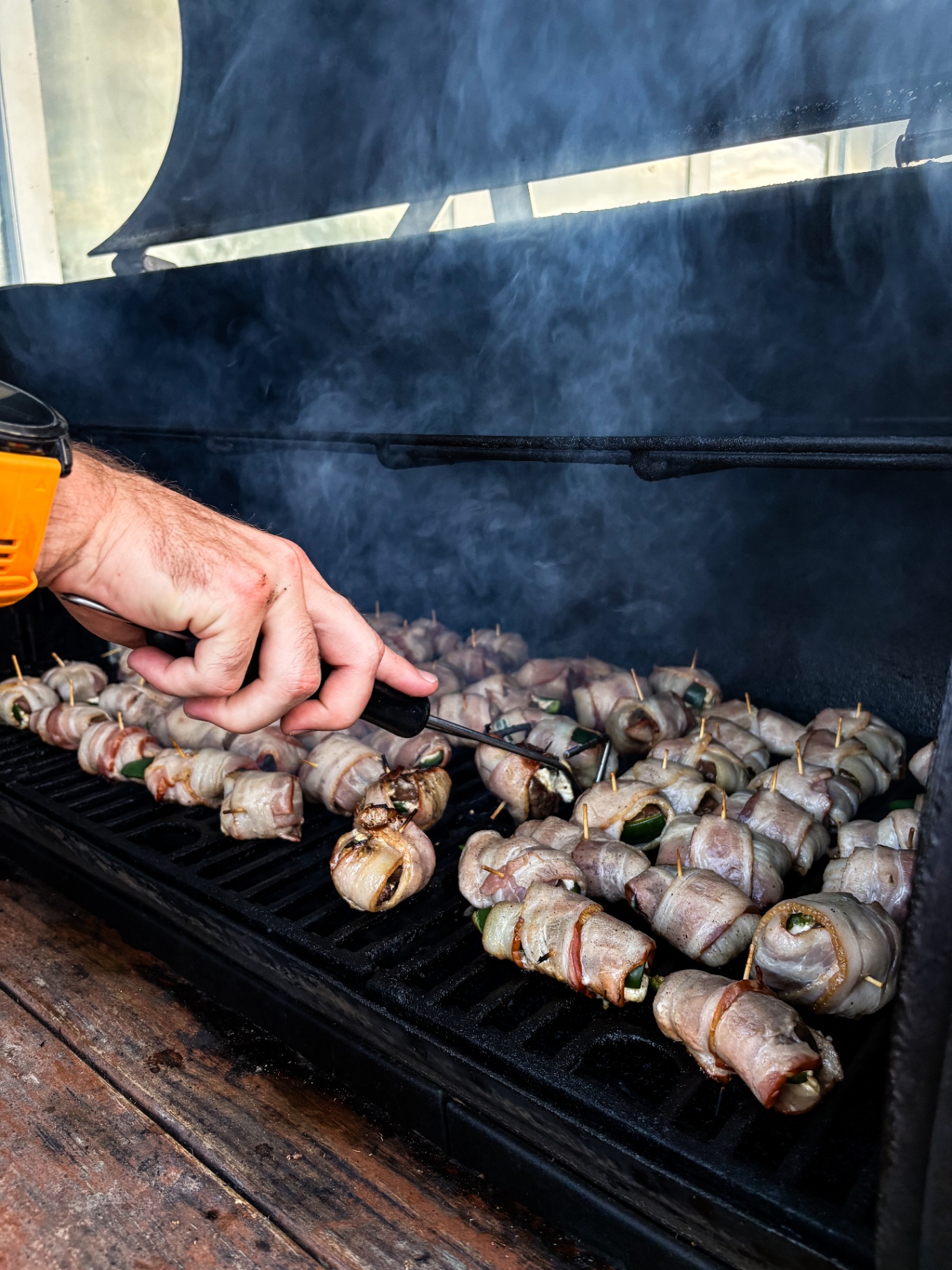 Bacon-wrapped poppers loaded on the grill