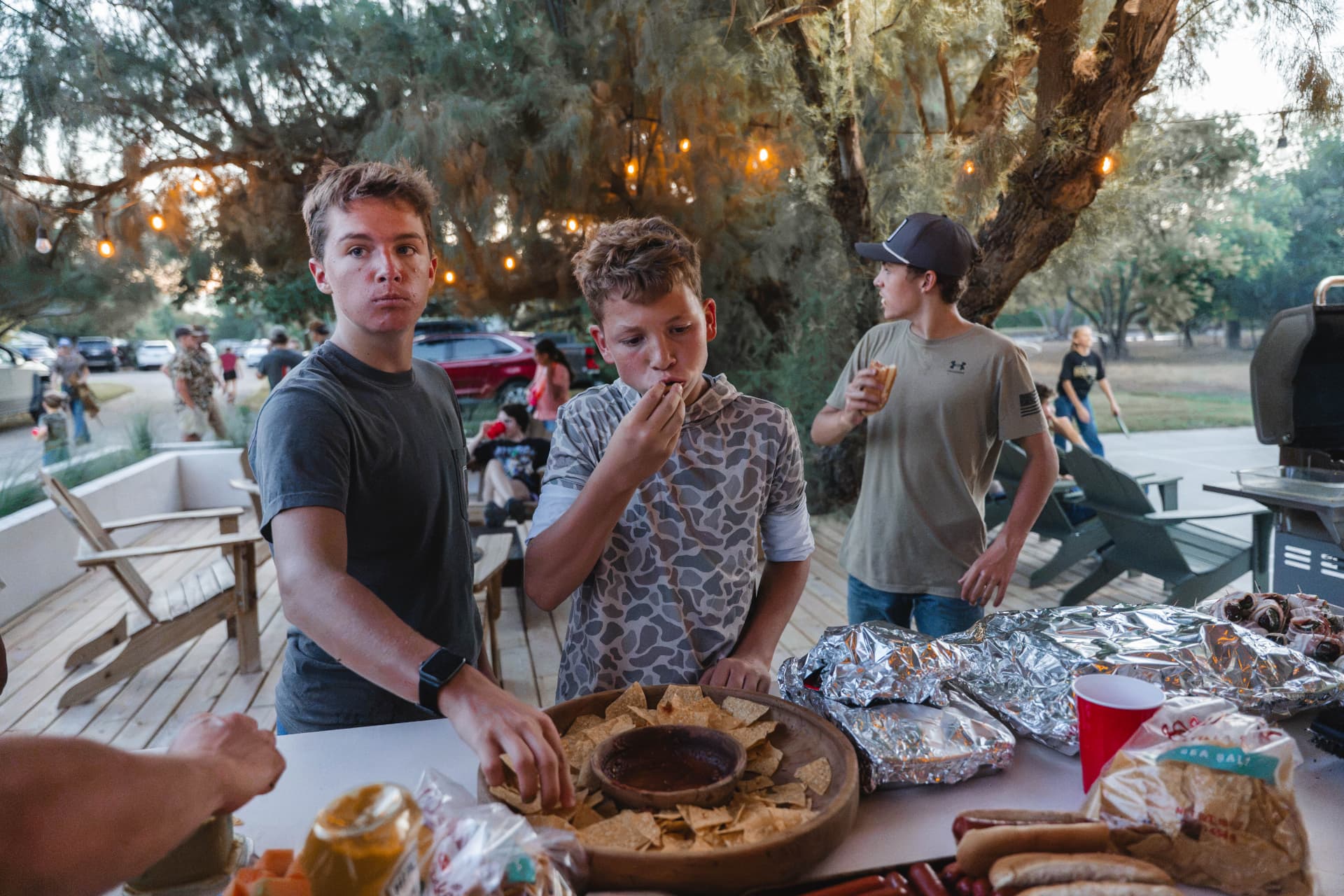 Boys grabbing snacks from the patio buffet