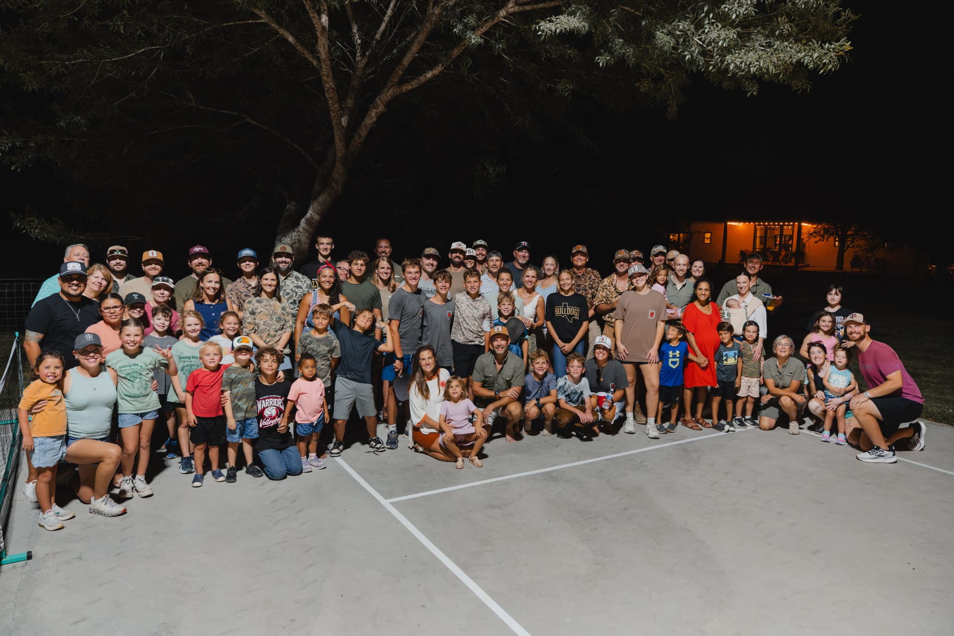 The whole crew posed together on the court at night