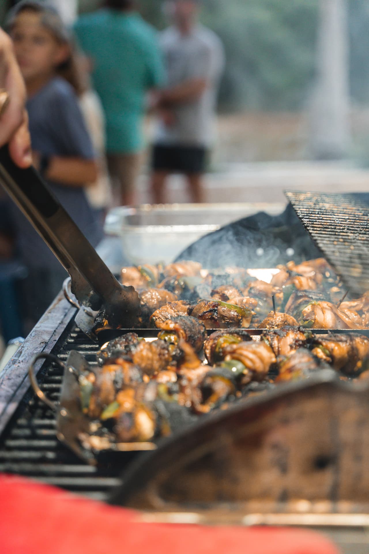 Turning bacon-wrapped bites on the grill