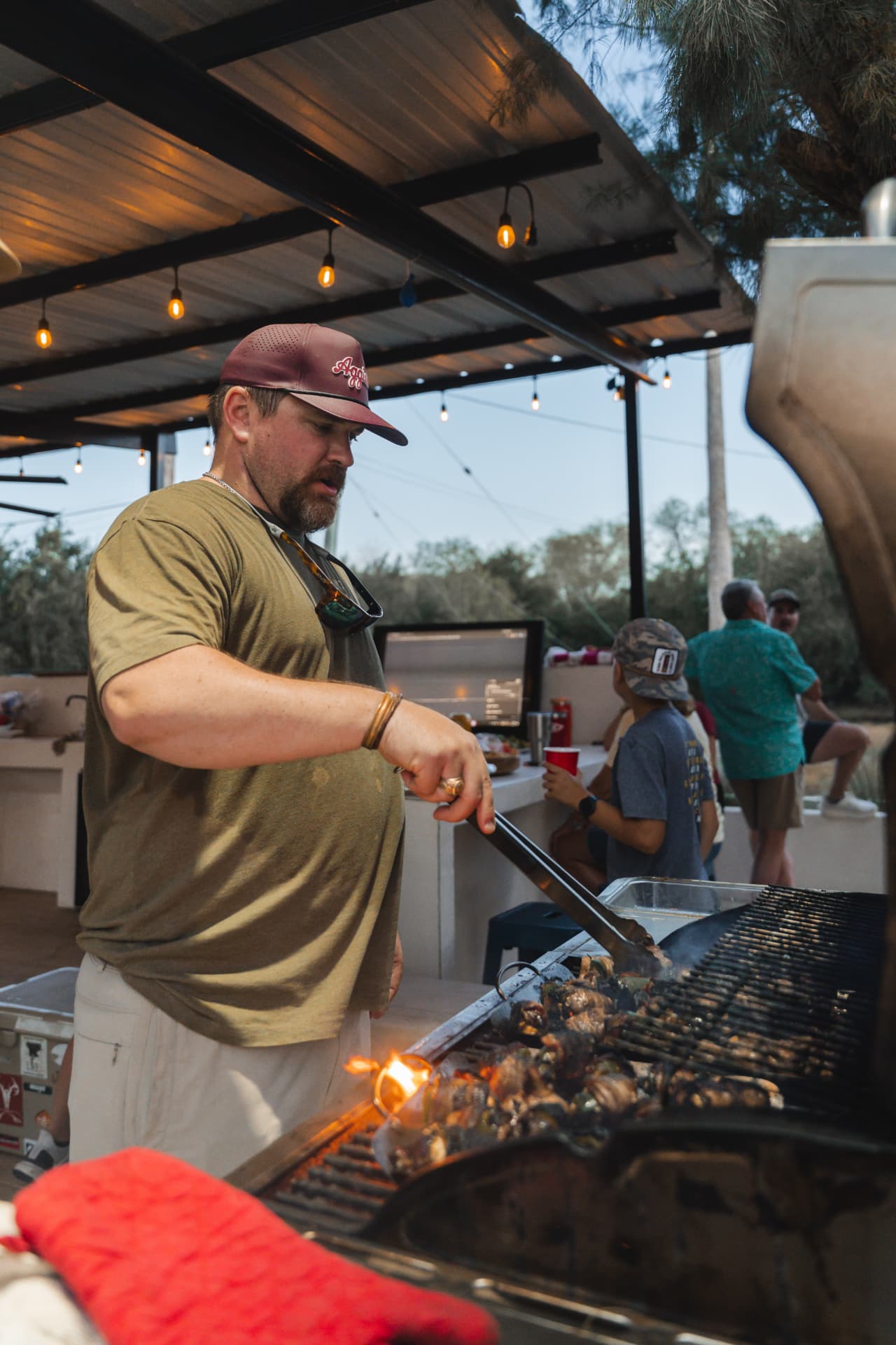 Grilling over open flames on the patio at dusk