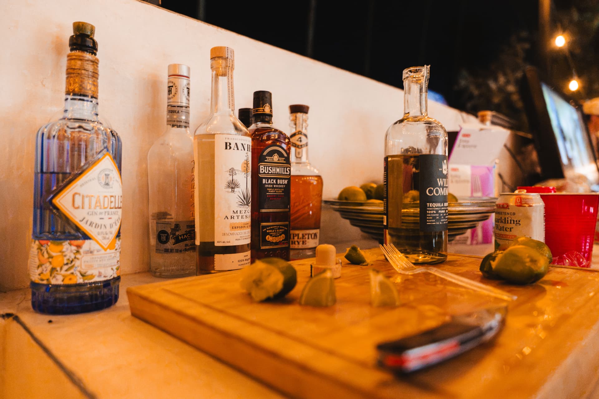Bottles, limes and a knife ready at the outdoor bar