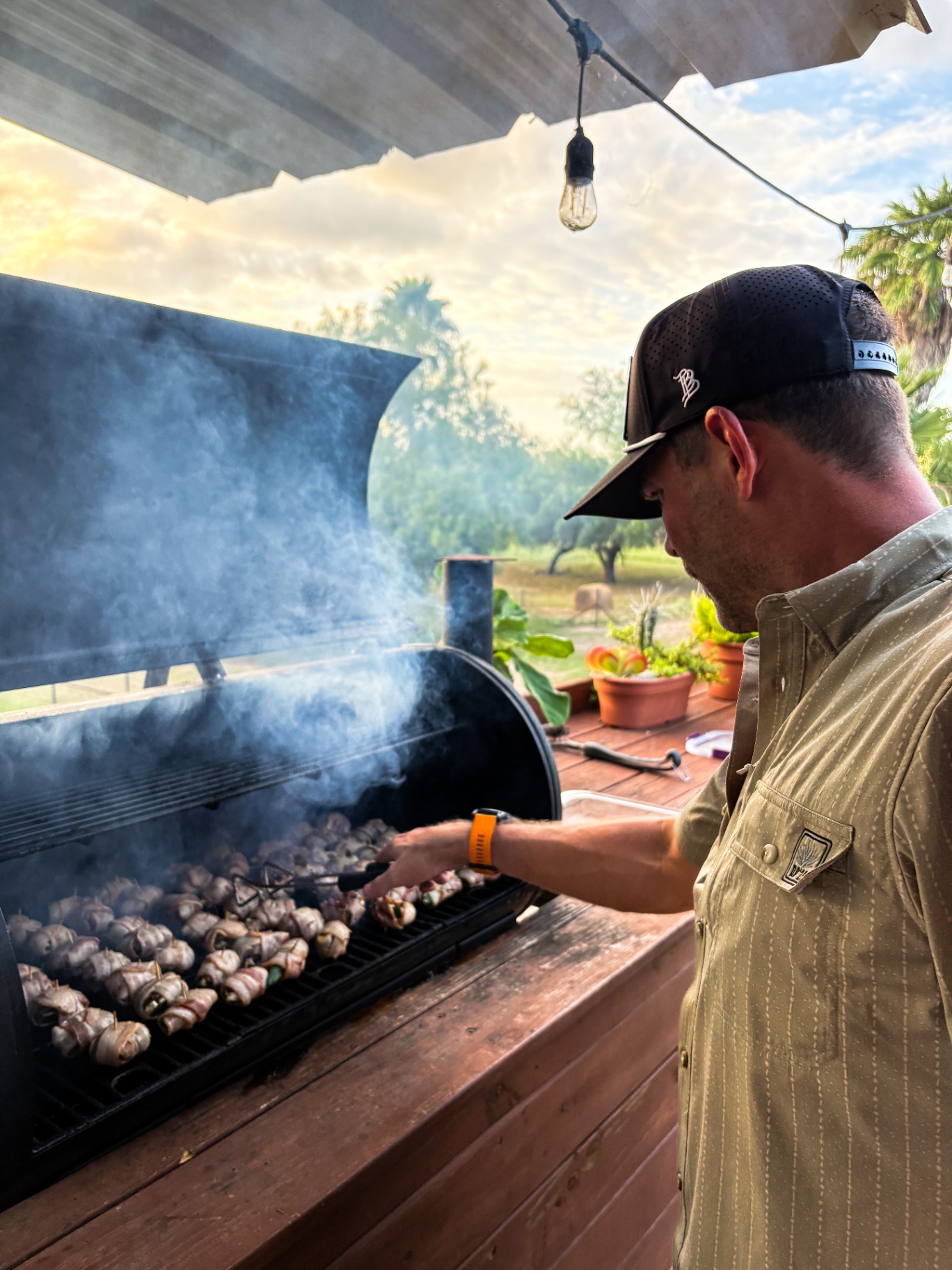 Tending the smoker at sunrise